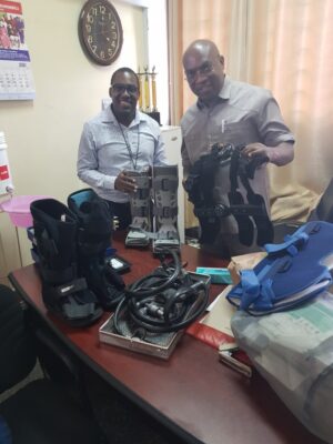 two of our tanzanian colleagues with surgical drill set and orthotic boots donated by orthocycle